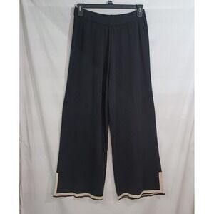 Loose-fitting black wide-leg pants with side slits, contrasting trim at the hem.